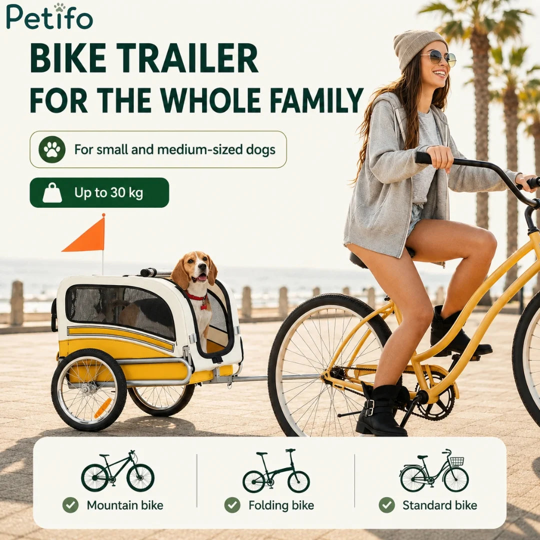 Woman riding bicycle pulling a Petifo dog bike trailer.