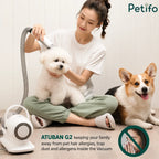 A woman uses an ATUBAN G2 pet grooming vacuum on a Bichon Frise to reduce pet hair allergens in the home.