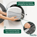 A person placing the removable pet bed cover into a mesh laundry bag for safe and easy machine washing.
