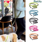 A woman using the Petifo dog leash hands-free next to a display of the five available color options.